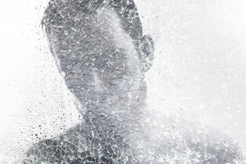 Man behind wet and cracked glass. Concepts of mental disorder or other social issues affecting...