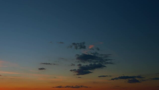 Panoramic view. Sunset sky with condensation trail. Dramatic warm near and far clouds at sunset. Timelapse.
