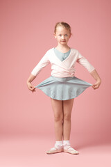 Cute Ballerina on Pink. Shot of cute little girl in her leotard against a studio background.