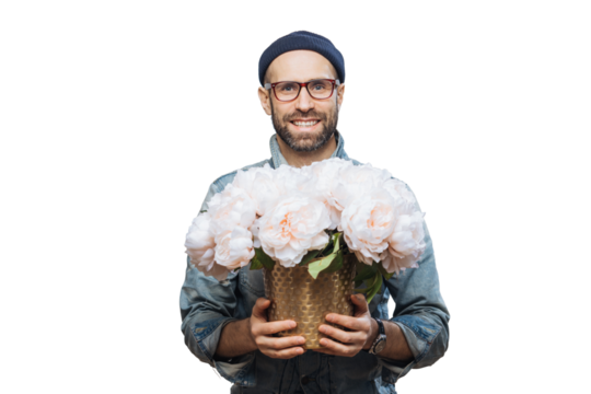 Positive unshaven male wears spectacles, holds beautiful bouquet of flowers, going to present them to his wife and congratulate with birthday, isolated over white background. People, presents concept