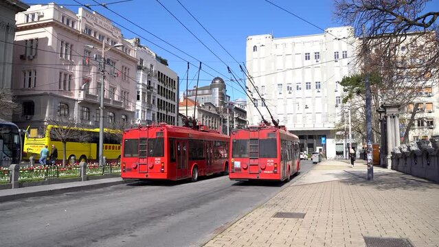 Old red electric bus in the city center. Belgrade, Serbia - April 2, 2023.