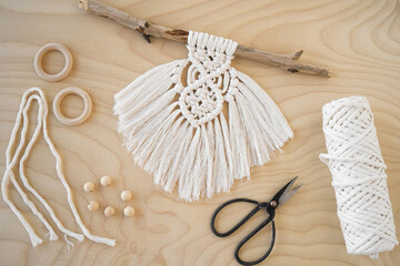 A Hand-Made Macrame Plant Hanger with Wooden Rings in a Beautiful Background Setting the Mood for Creativity.