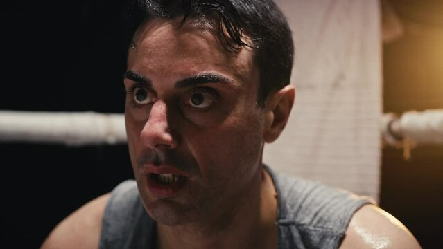Tired boxer sitting at ringside
