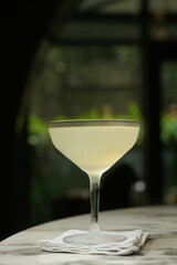 Margarita cocktail glass with martini and dry lemon slice