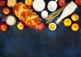 Jewish Shavuot Holiday Card. Dairy Products, Apples, Cheese, Bread, Milk on Blue Wooden Background.