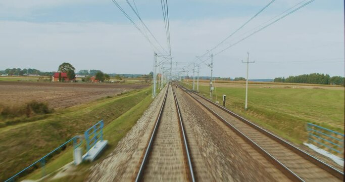 Train journey point of view from driver's view. Train ride from the point of view of the last carriage of the train. Railroad track from a train POV perspective.