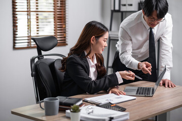 Fototapeta premium Young confident business people sitting at the office table working analyze on laptop computer with partner. Business concept