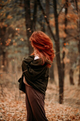 redhair woman in the fall  forest