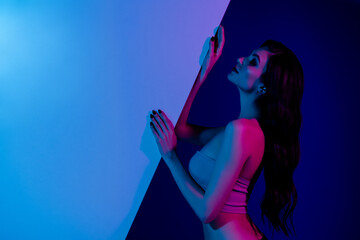 Side portrait of stunning girlfriend at disco party modern event hold blue neon wall advertising...