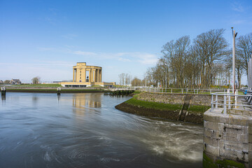 Overview at the Westfront located at city Nieuwpoort at the belgium coast.  River de ijzer with the Koning Albert I monument and a blue sky.  Belgium coast toerism picture.  With the water dam.