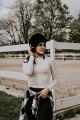 A woman instructor teaching girl how to ride a horse.  Female rider practicing on a horseback learning equestrian sport. Active lifestyle and leisure activity concep