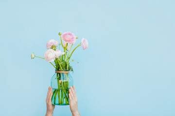 Flowers to gift. Beautiful ranunculus in female hands. Spring time and inspiration