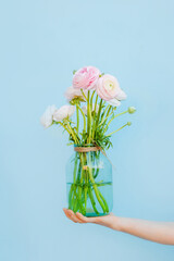 Flowers to gift. Beautiful ranunculus in female hands. Spring time and inspiration