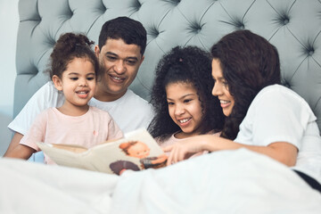Smiling like he hit the lottery. Shot of a beautiful young family talking and bonding in bed...