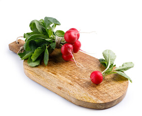 Red radish on a wooden cutting board isolated in white background