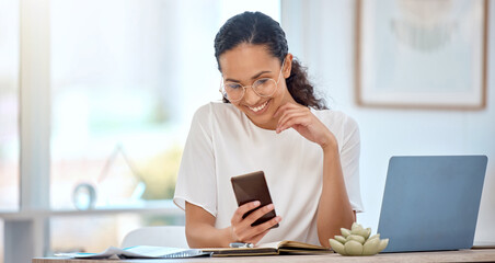 Lunch breaks are for scrolling. Shot of a beautiful woman using a cellphone while working in a...