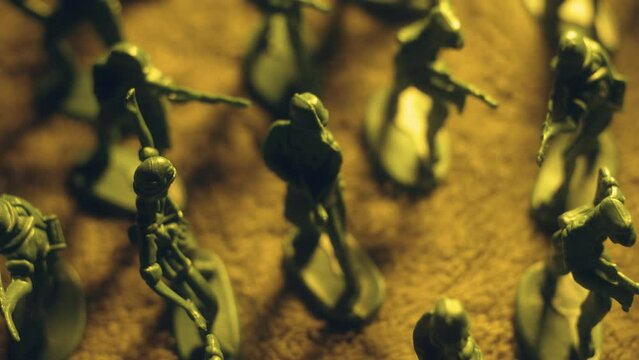 Shoulder to shoulder, toy soldiers take their stance on battlefield macro shots. Violence war resistance and peace without armored invasion