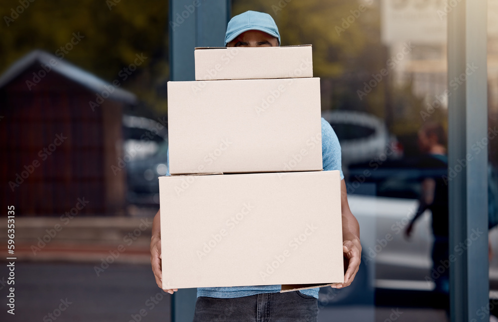 Poster manage tons of orders on the daily. shot of a young delivery man holding a pile of boxes.