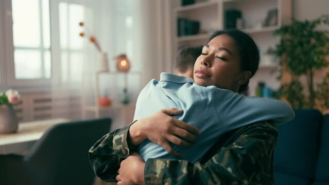 Boy hugging his mom leaving for military service, serving in armed forces, love - Powered by Adobe