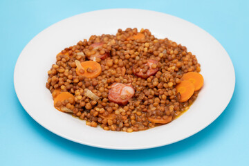 Lentils with chorizo and carrot. Typical Spanish recipe.