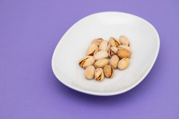 fresh salted pistachio on white small dish