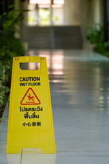Caution wet floor warning sign on the walkway hotel corridor,Cleaning service