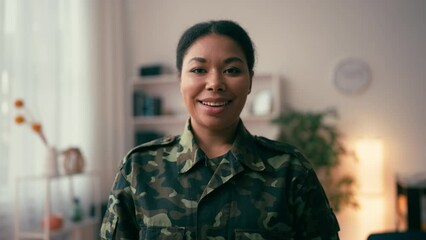Portrait of smiling African American military woman at home, serving the country