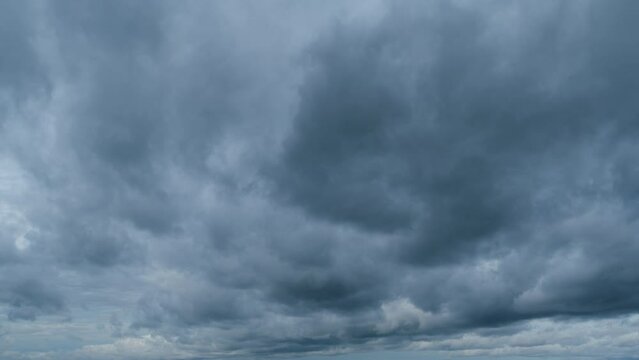 Sky before storm. Stormy cloudy sky wide panorama. Storm cloudy dramatic sky with dark rain grey cumulus cloud and blue sky. Timelapse.