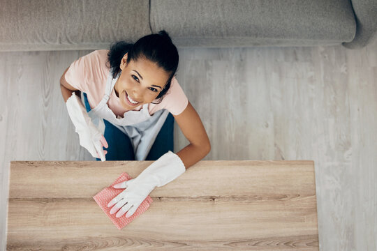 I have a few tips on keeping your house spotless. Shot of a woman wiping surfaces at home.