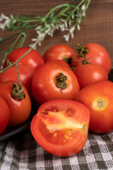 Fresh red tomatoes with water drops on a dark background. Harvesting tomatoes. Top view