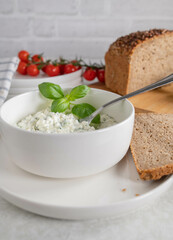Cottage cheese salad with herbs and olive oil. Served with rye bread. Healthy low fat and protein meal