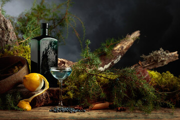 Gin with lemon and an antique bottle of dark green glass.