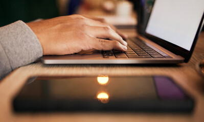 Closeup of unknown mixed race man sitting alone at night and using a laptop to browse the internet. Hispanic student typing and researching online. Macro view of man using technology to learn a course