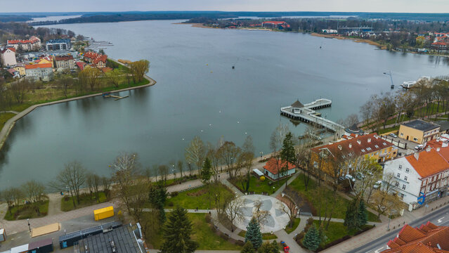 View of the Drwęckie lake and the city of Ostróda on a cloudy spring day.