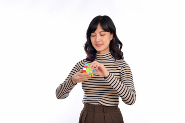 Asian woman holding a puzzle cube standing on white background. solving cubic problems, problem solution and making strategic moves concept