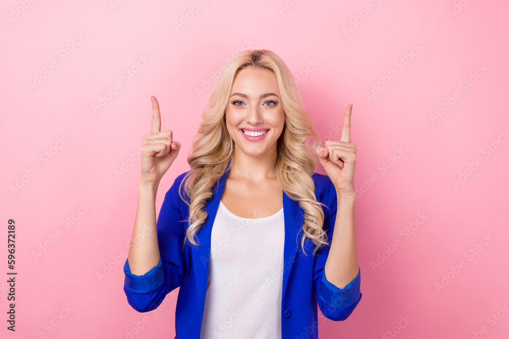 Sticker Portrait of smiling optimistic good mood lady wear blue blazer direct fingers up empty space promoter newspaper ad isolated on pink color background