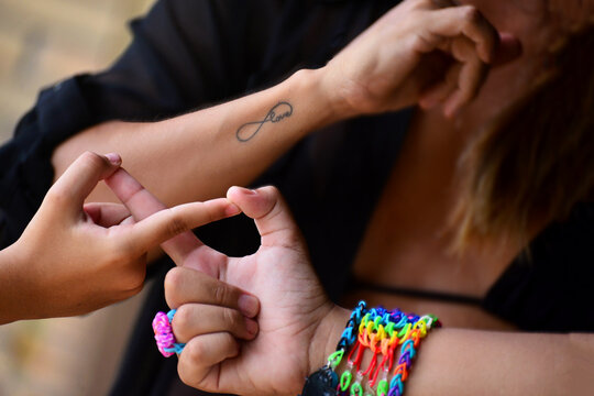 hands, infinity symbol, friendship day, friends forever, infinity sign, tattoo, infinity symbol tattoo, brotherly love, colorful bracelets, rainbow colors, mother and daughters, symbolic gesture