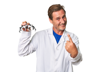 A middle-aged optometrist man pointing with finger at you as if inviting come closer.