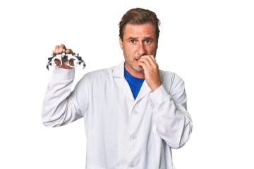 A middle-aged optometrist man biting fingernails, nervous and very anxious.