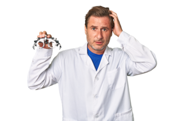 A middle-aged optometrist man being shocked, she has remembered important meeting.