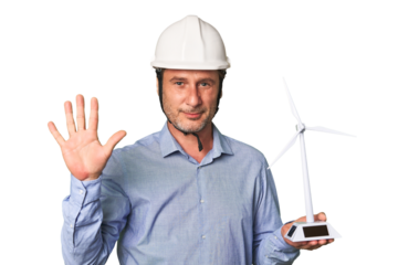 A middle-aged architect man holding a windmill model smiling cheerful showing number five with fingers.