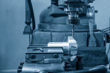 The drilling process on NC milling machine with automotive parts.