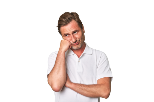 A middle-aged man isolated who feels sad and pensive, looking at copy space.