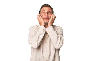 A middle-aged man isolated crying, unhappy with something, agony and confusion concept.
