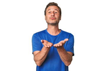 A middle-aged man isolated folding lips and holding palms to send air kiss.