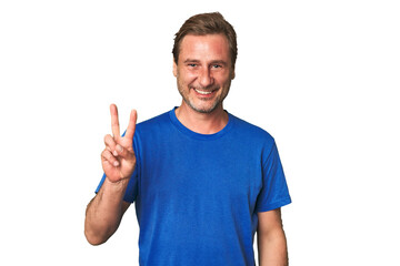 A middle-aged man isolated showing victory sign and smiling broadly.