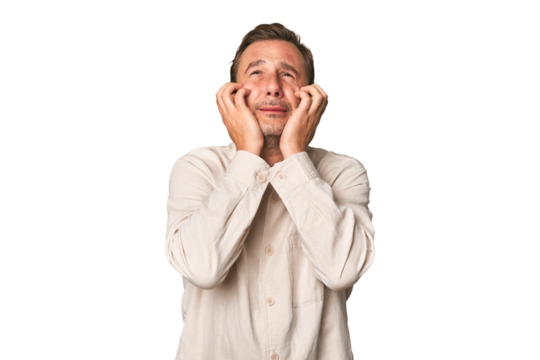 A middle-aged man isolated crying, unhappy with something, agony and confusion concept.