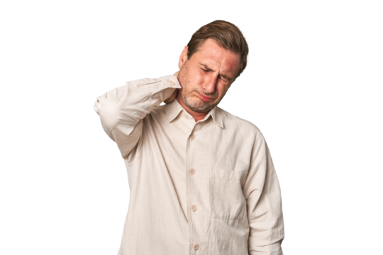A middle-aged man isolated having a neck pain due to stress, massaging and touching it with hand.