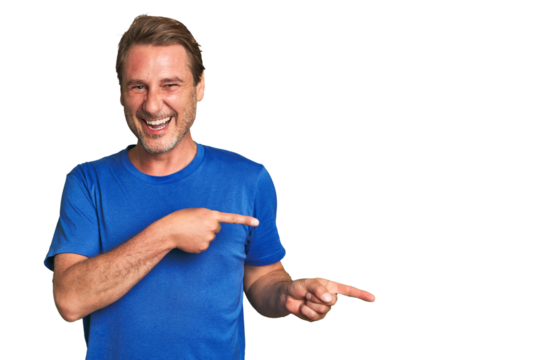 A middle-aged man isolated pointing with forefingers to a copy space, expressing excitement and desire.