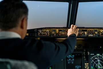 Commercial aircraft pilot adjusts aircraft flight parameters during high altitude flight View from inside the cabin
